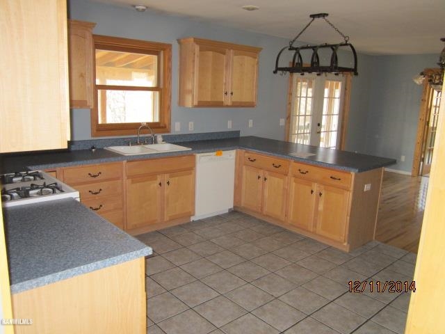 6 Snipe Hollow Road Elizabeth, IL 61028 - Photo 9 of 23 a kitchen with granite countertop a sink a stove and cabinets
