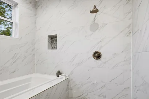a bathroom with a bathtub and a sink