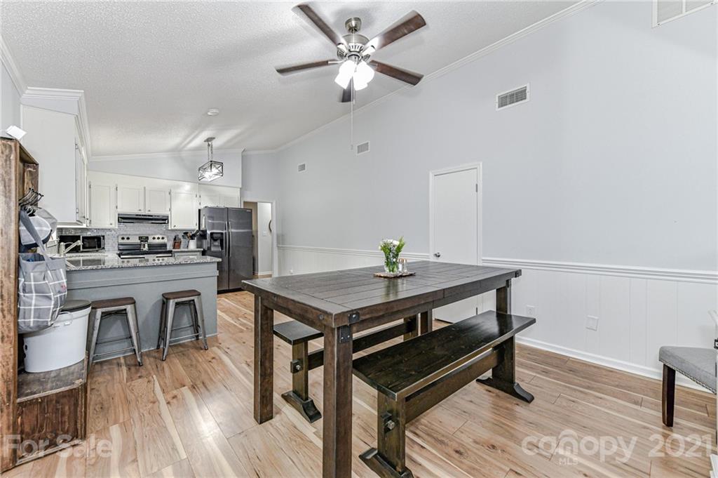 1706 Carson Street Monroe, NC 28110 - Photo 13 of 36 a view of kitchen with cabinets table and chairs