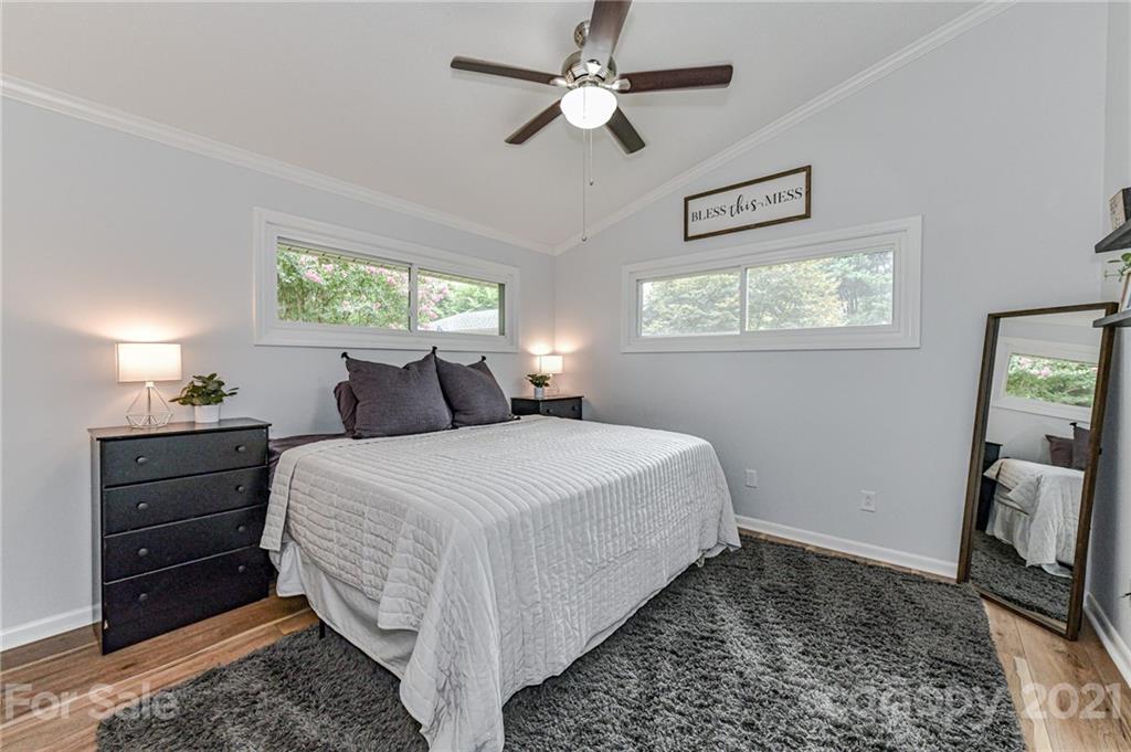 1706 Carson Street Monroe, NC 28110 - Photo 16 of 36 a bedroom with a bed and a flat tv screen on dresser