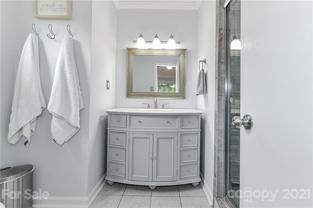 1706 Carson Street Monroe, NC 28110 - Photo 18 of 36 a bathroom with a sink vanity and a mirror