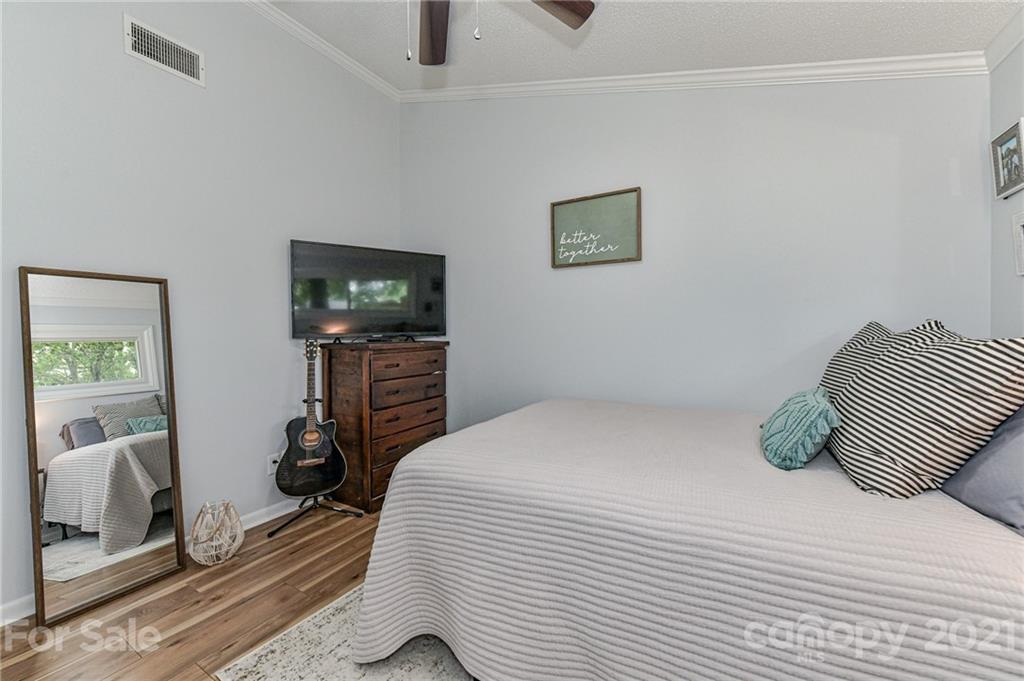 1706 Carson Street Monroe, NC 28110 - Photo 21 of 36 a bedroom with a bed and flat screen tv