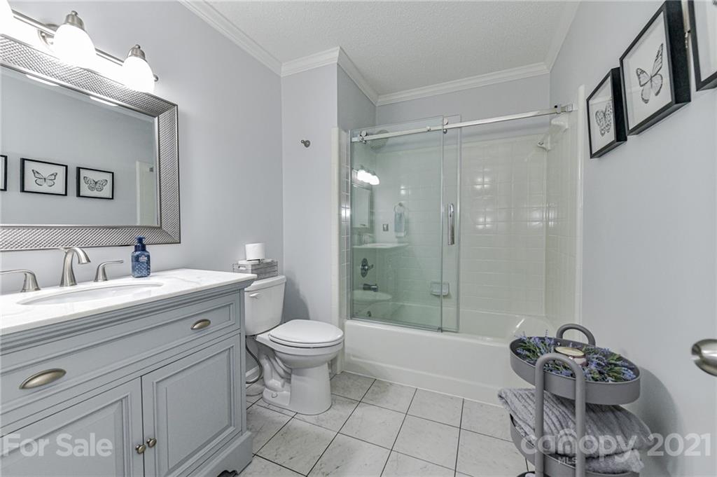 1706 Carson Street Monroe, NC 28110 - Photo 22 of 36 a bathroom with a sink toilet a mirror and shower