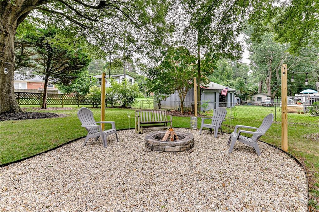 1706 Carson Street Monroe, NC 28110 - Photo 30 of 36 a view of a park with chairs and a big yard