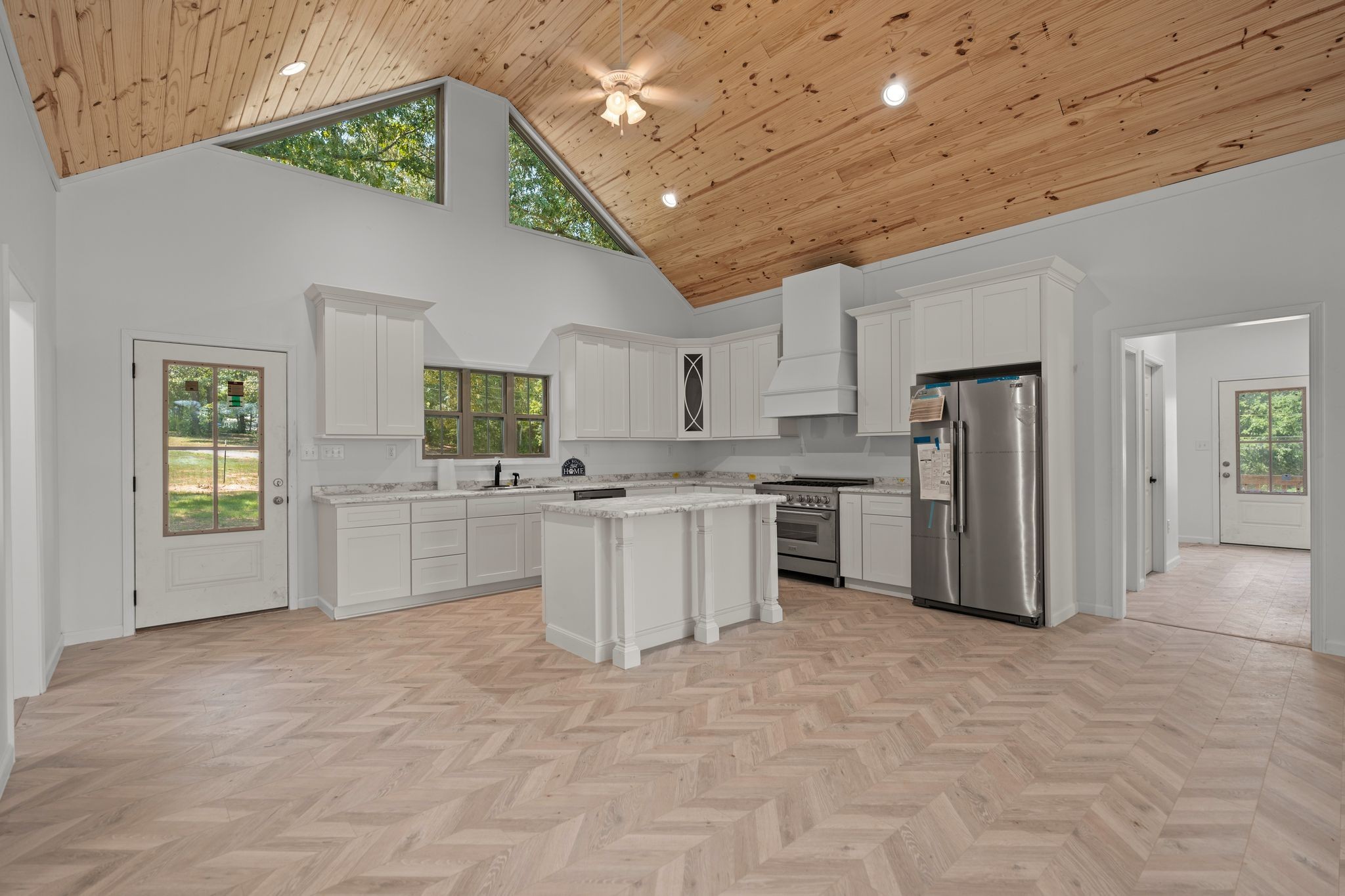 324 Fisherdale Drive Decaturville, TN 38329 - Photo 22 of 36 a large white kitchen with cabinets and a refrigerator