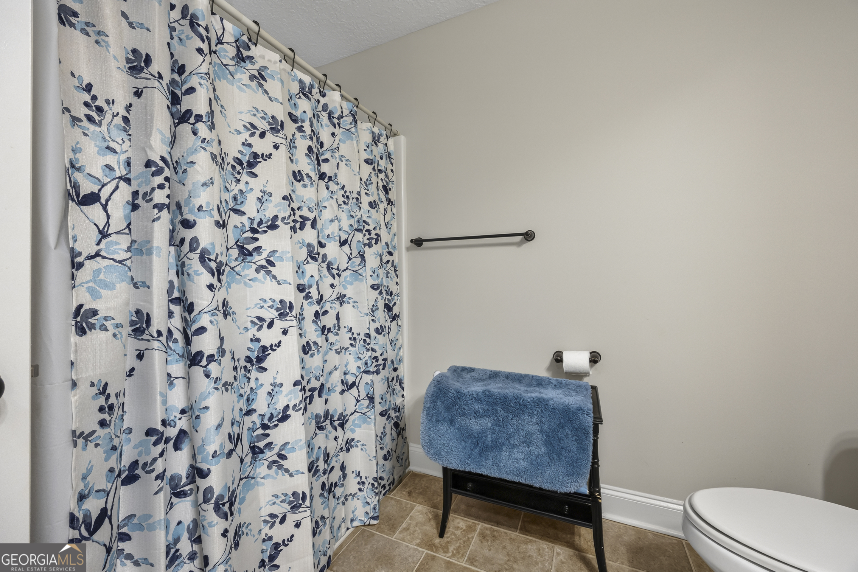 717 Oconee Lane Commerce, GA 30529 - Photo 43 of 57 a bathroom with a toilet and a shower curtain