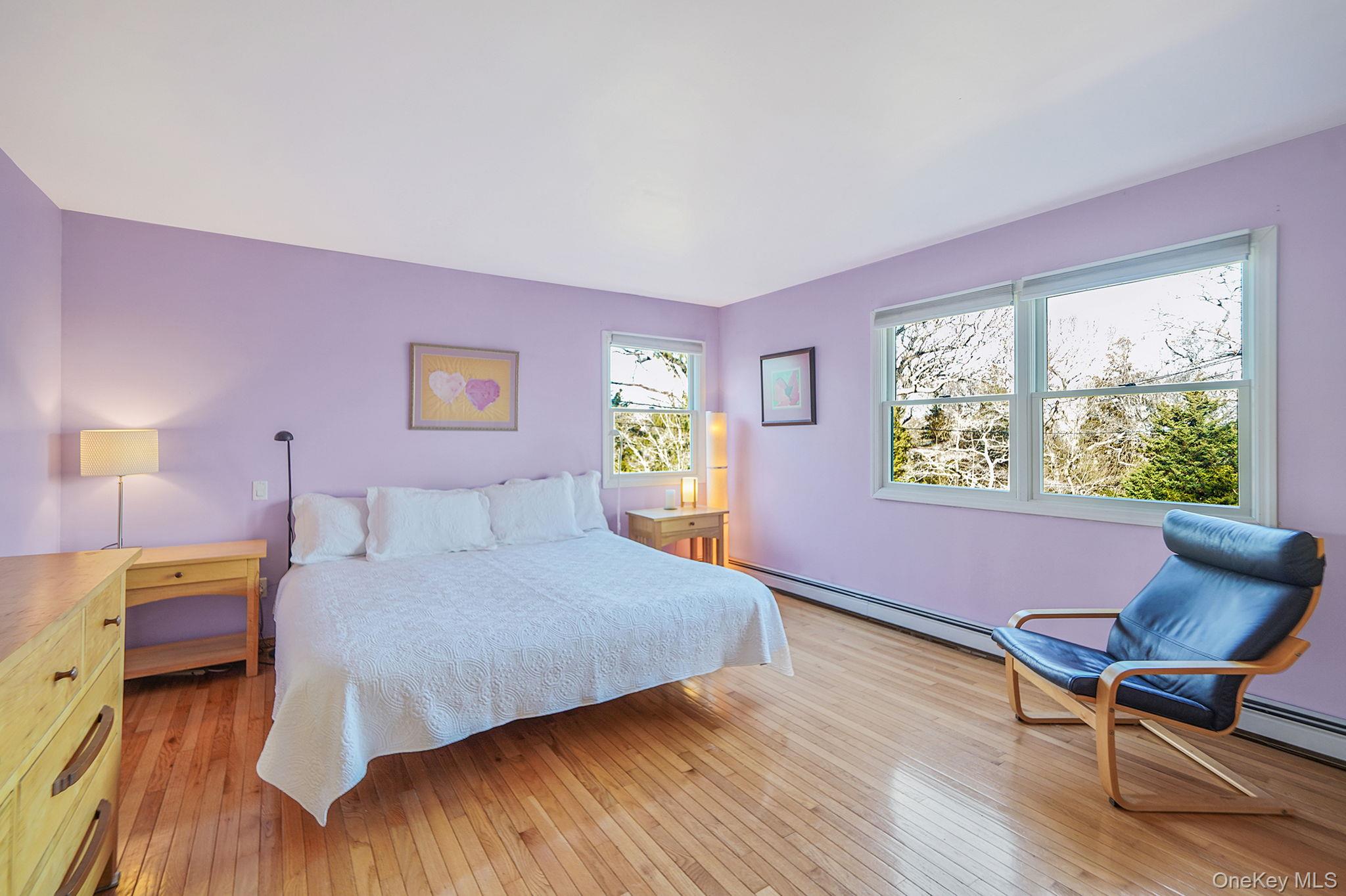 12 Harbor Beach Road Miller Place, NY 11764 - Photo 19 of 45 Bedroom featuring a baseboard heating unit and light wood finished floors