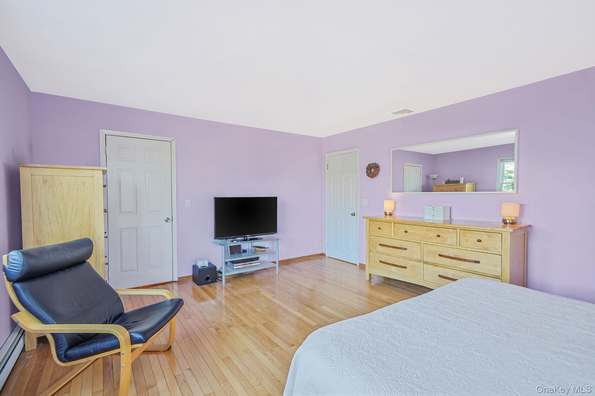 12 Harbor Beach Road Miller Place, NY 11764 - Photo 20 of 45 Bedroom with light wood-type flooring and a baseboard heating unit