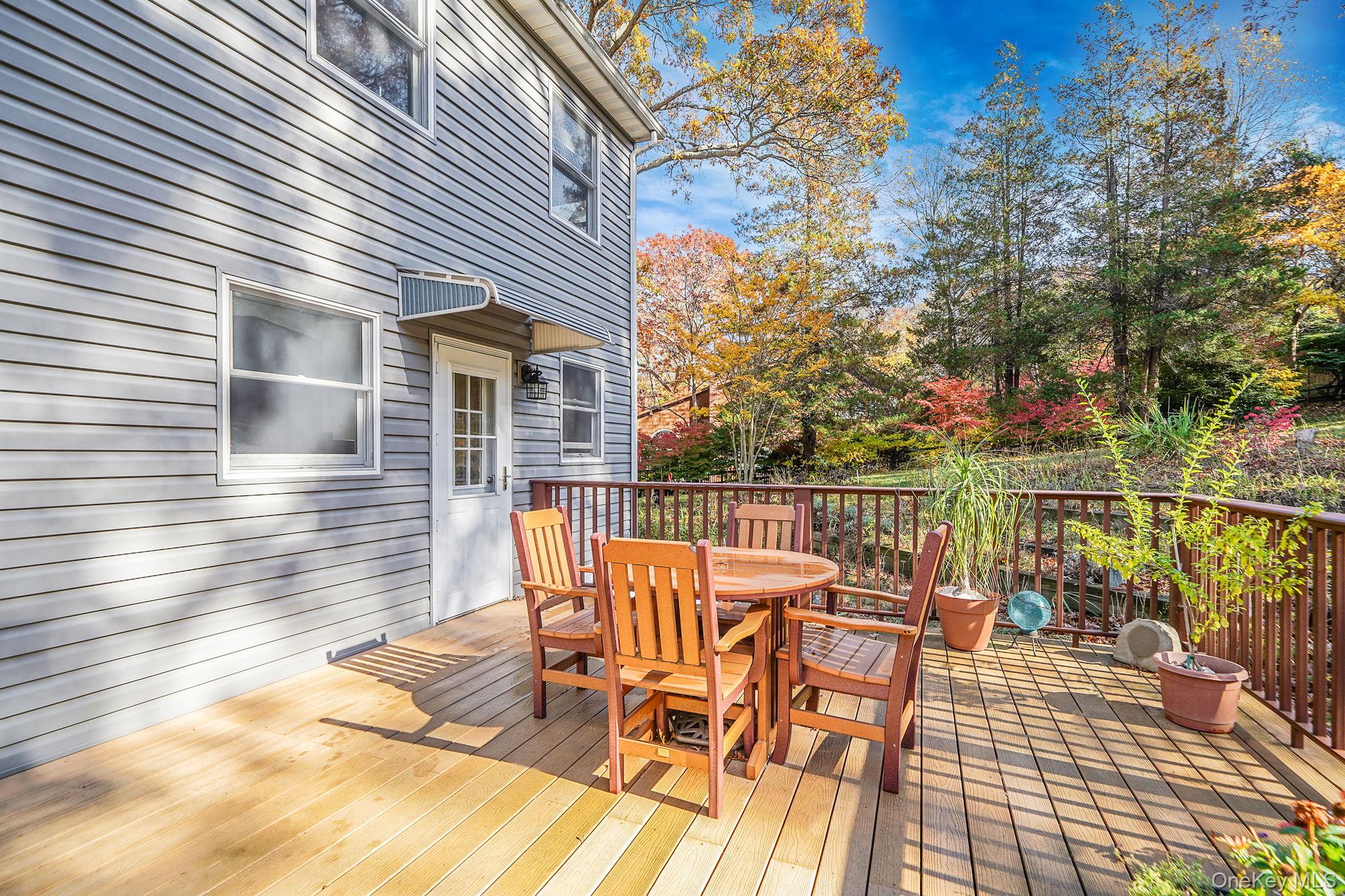 12 Harbor Beach Road Miller Place, NY 11764 - Photo 38 of 45 Deck featuring outdoor dining space and view of wooded area