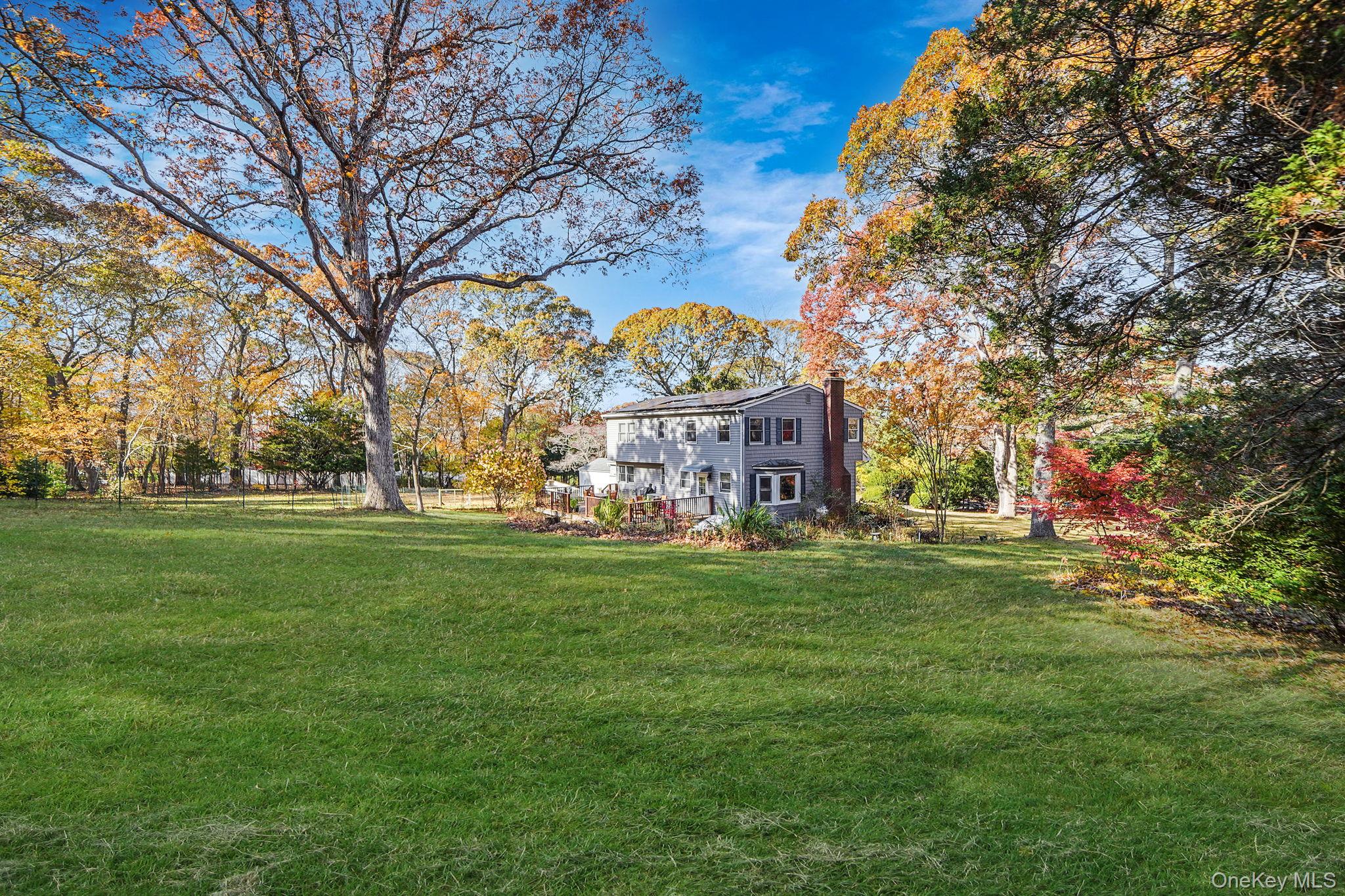 12 Harbor Beach Road Miller Place, NY 11764 - Photo 40 of 45 View of green lawn with view of wooded area