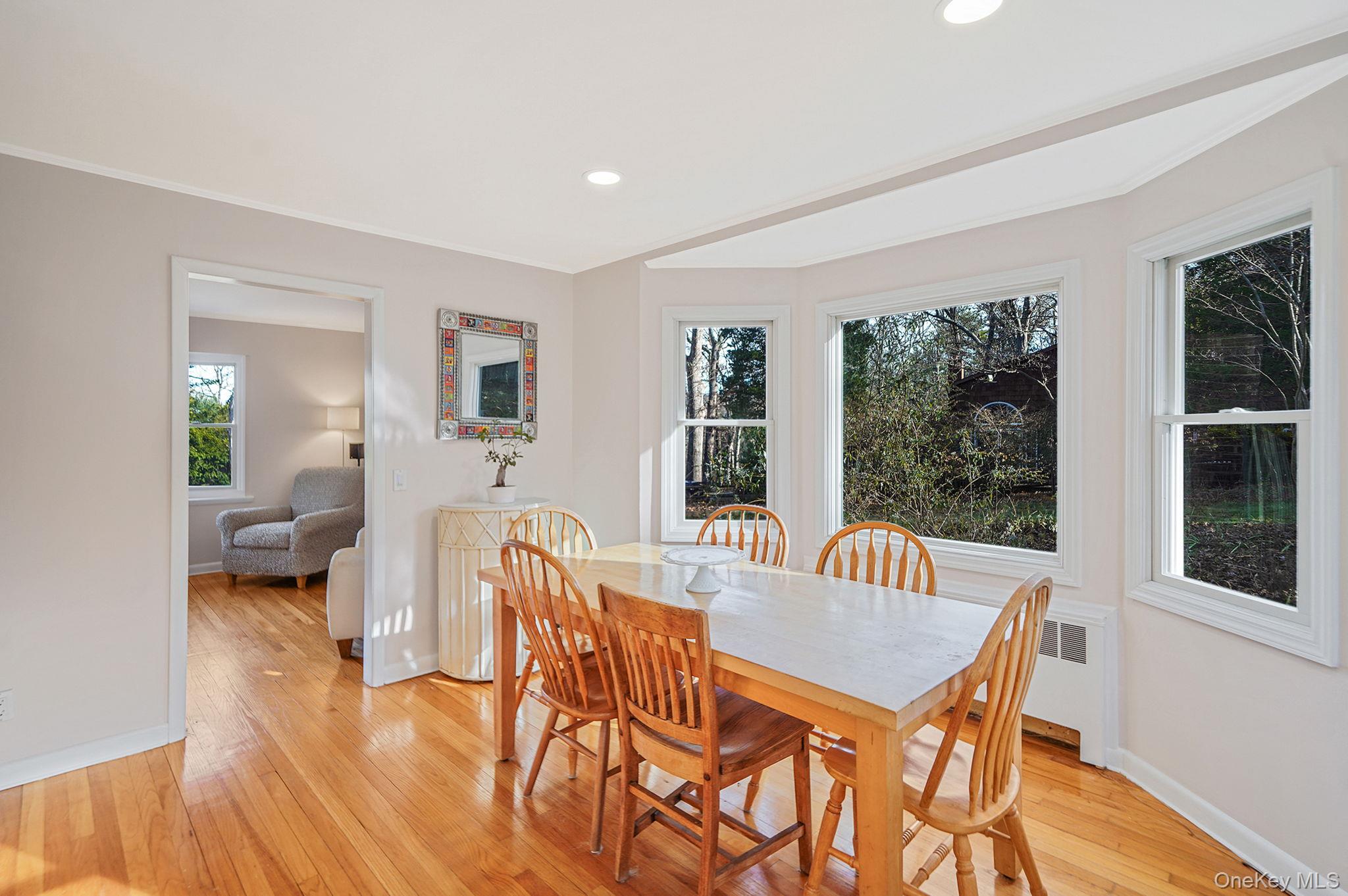 12 Harbor Beach Road Miller Place, NY 11764 - Photo 7 of 45 Dining area featuring light wood-type flooring, recessed lighting, and radiator heating unit