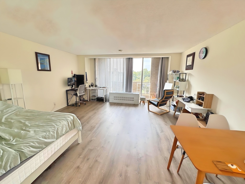 44 Washington Street, Unit 814 Brookline, MA 02445 - Photo 1 of 15 a bed room with a bed and a couch