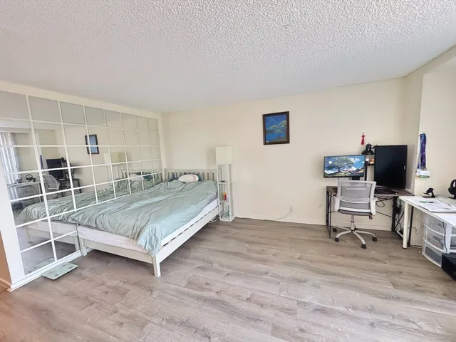 a bedroom with a bed and flat screen tv
