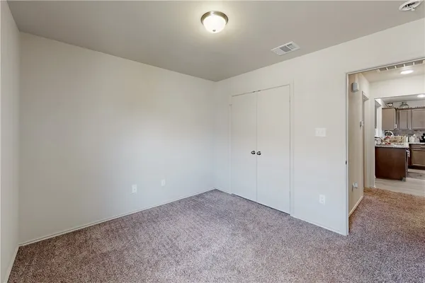 an empty room with closet area