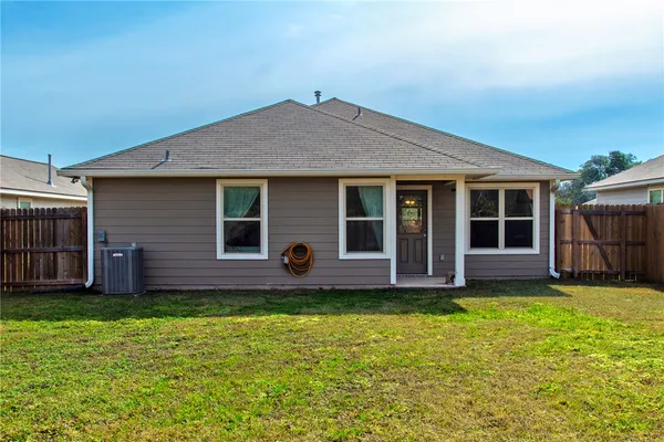 a view of a house with a yard and sitting area