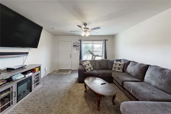 a living room with furniture and a flat screen tv