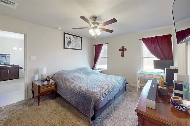 a bedroom with a bed and a chandelier