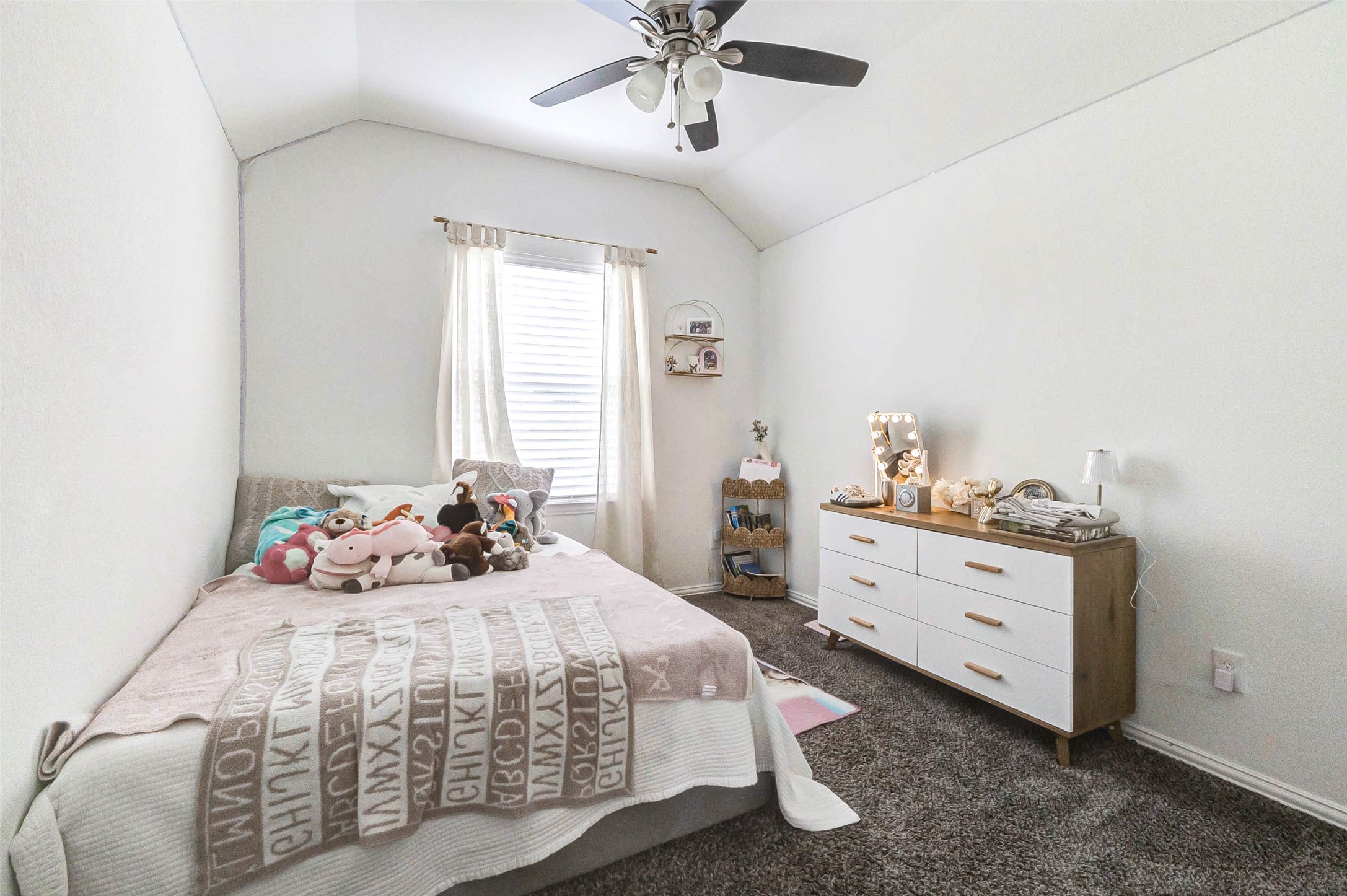 3210 Montclair Orchard Trace Spring, TX 77386 - Photo 25 of 38 a bedroom with a bed and a chandelier