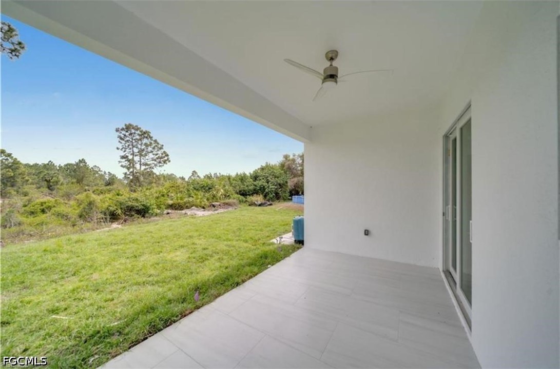 222 Pullman Street Lehigh Acres, FL 33974 - Photo 9 of 9 a view of a big yard with potted plants