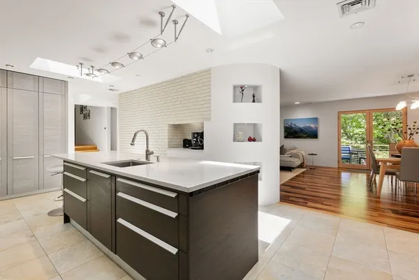 a kitchen with stainless steel appliances granite countertop a sink and a stove