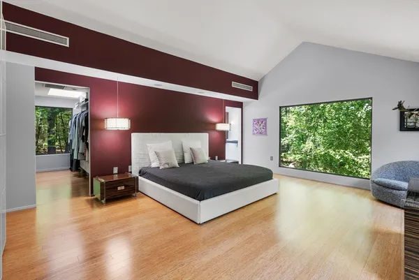 a bedroom with a bed and window