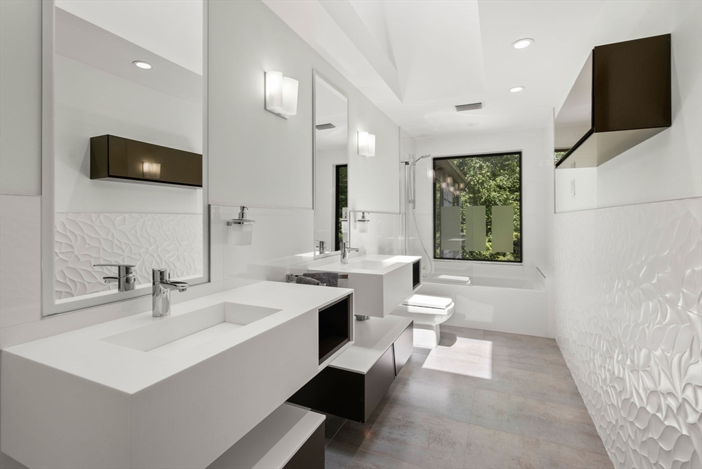 169 Hickory Road Weston, MA 02493 - Photo 23 of 30 a bathroom with a sink a large mirror and a toilet