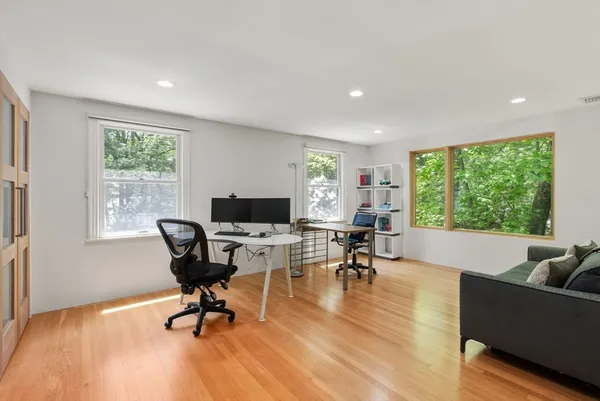 a workspace with wooden floor and a window