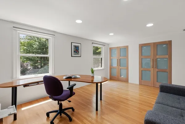 a view of a livingroom with furniture and a workspace