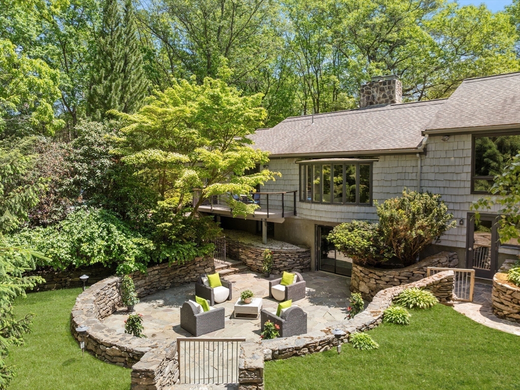 169 Hickory Road Weston, MA 02493 - Photo 28 of 30 a view of a patio with couches table and chairs and potted plants