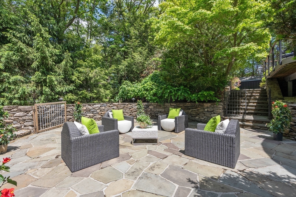 169 Hickory Road Weston, MA 02493 - Photo 29 of 30 a view of a patio with couches and a potted plant