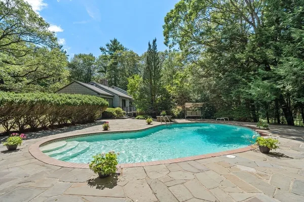 a view of a backyard with swimming pool