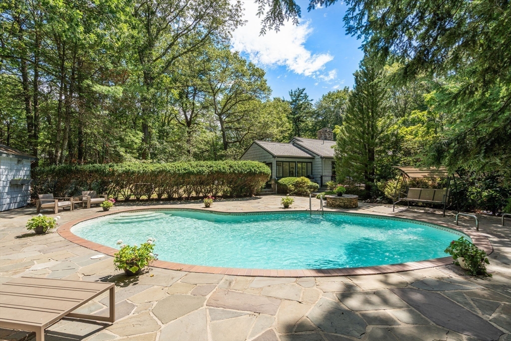 169 Hickory Road Weston, MA 02493 - Photo 4 of 30 a view of a swimming pool with a patio
