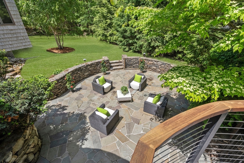 169 Hickory Road Weston, MA 02493 - Photo 5 of 30 a view of a backyard with couches chair and a table with potted plants