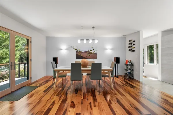 a view of a dining room with furniture a chandelier and wooden floor
