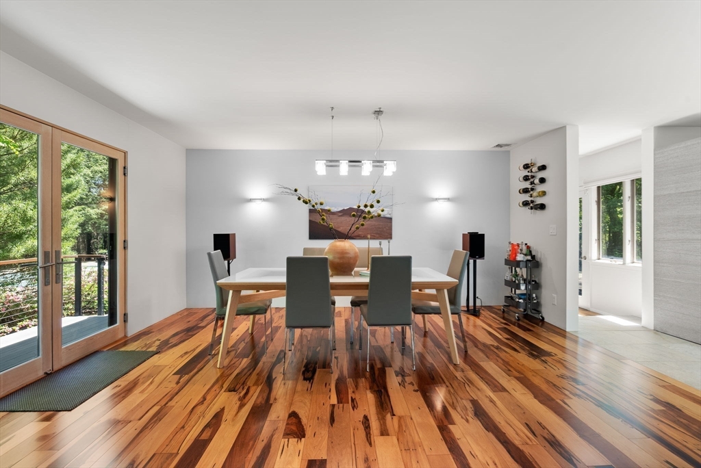 169 Hickory Road Weston, MA 02493 - Photo 8 of 30 a view of a dining room with furniture a chandelier and wooden floor