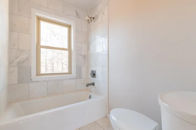a bathroom with a shower sink and mirror