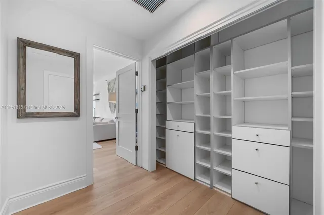 a view of walk in closet with empty racks