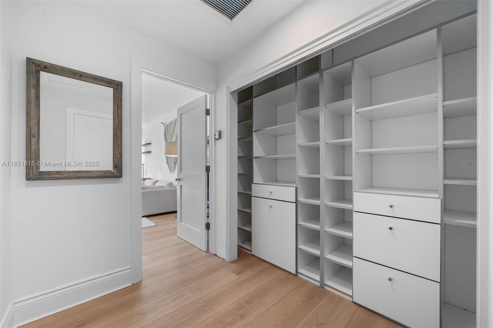 200 Ocean Ln Drive, Unit 108 Key Biscayne, FL 33149 - Photo 17 of 39 a view of walk in closet with empty racks