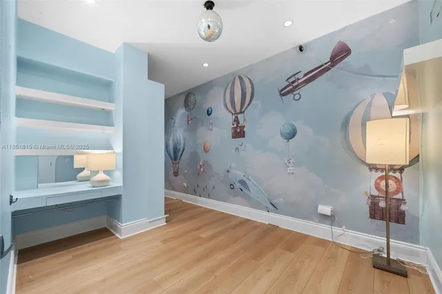 a view of a hallway with wooden floor and entryway