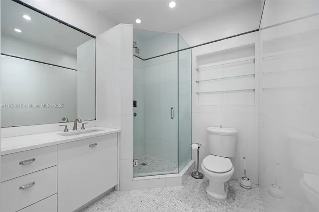 a bathroom with a toilet sink and shower