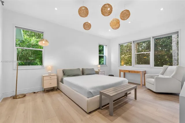 a bedroom with a bed and a large window