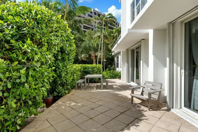 a view of a patio with table and chairs and potted plants