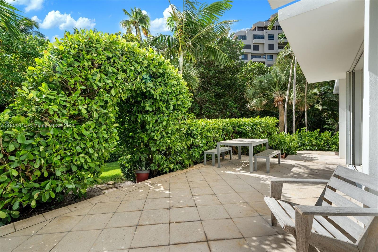 200 Ocean Ln Drive, Unit 108 Key Biscayne, FL 33149 - Photo 32 of 39 a view of a patio with table and chairs and potted plants