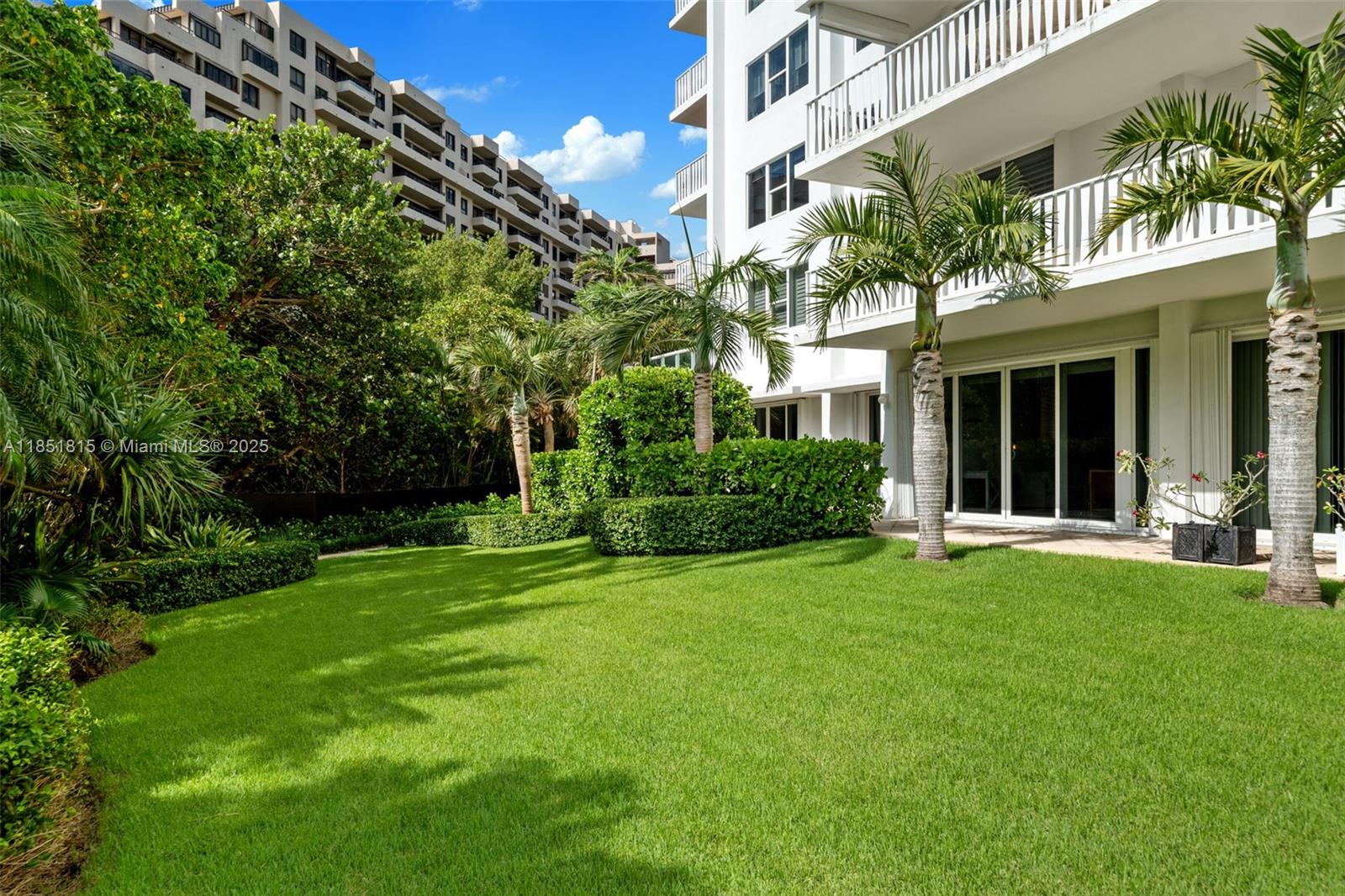 200 Ocean Ln Drive, Unit 108 Key Biscayne, FL 33149 - Photo 34 of 39 a front view of a house with a garden