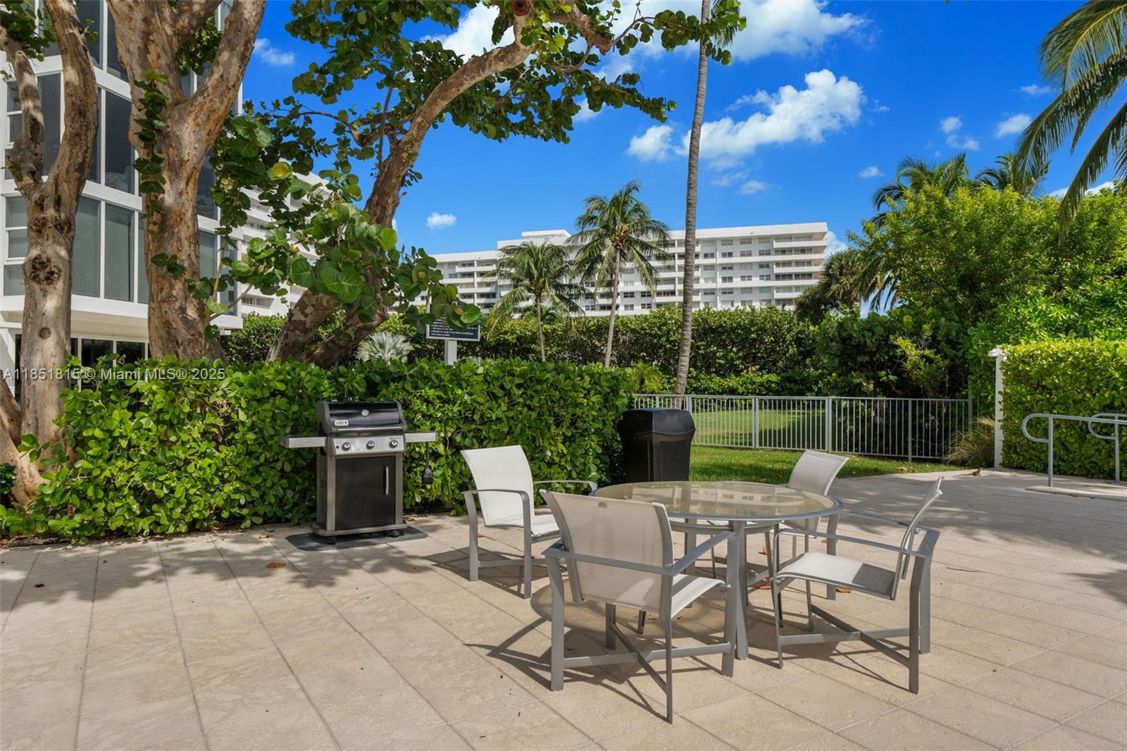 200 Ocean Ln Drive, Unit 108 Key Biscayne, FL 33149 - Photo 38 of 39 a view of backyard with seating space and trees