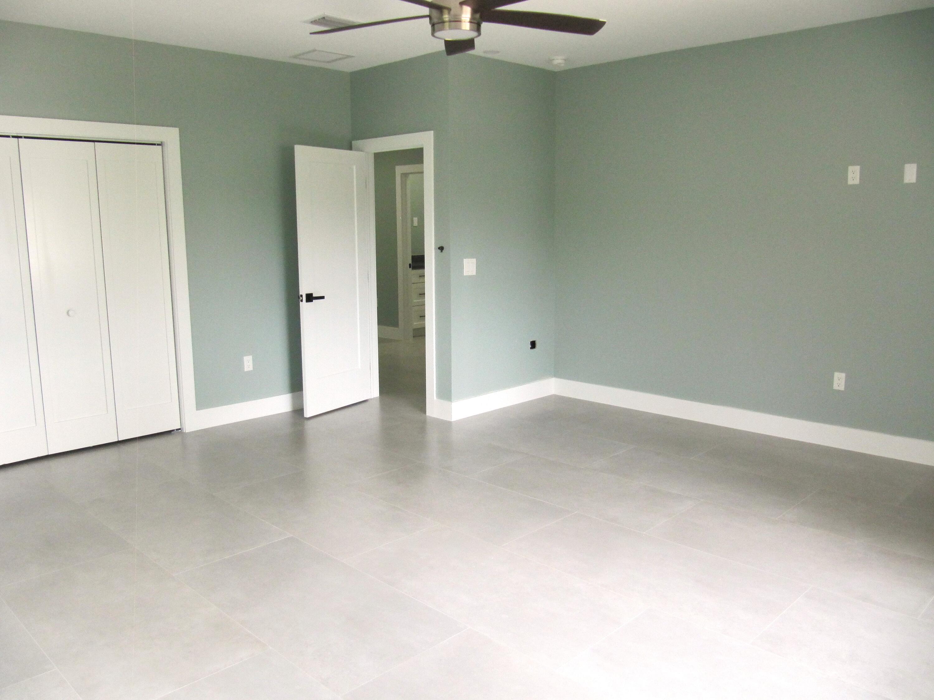 25 Abaco Road Key Largo, FL 33037 - Photo 12 of 17 an empty room with windows and a ceiling fan