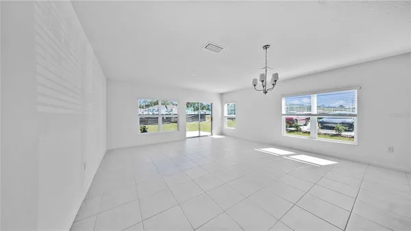 an empty room with windows and outdoor view