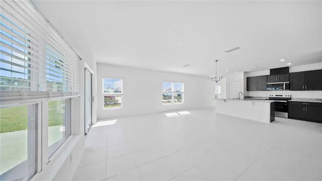 a view of open kitchen with kitchen island and stainless steel appliances