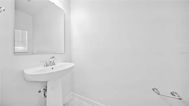 a bathroom with a sink a mirror and a window