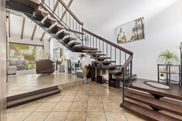 a kitchen with stainless steel appliances granite countertop a dining table chairs and granite counter tops
